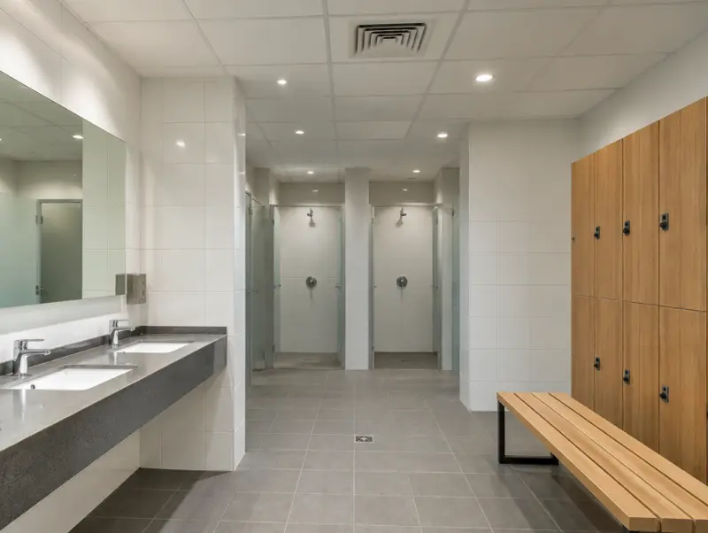 Changing room with a moisture-resistant white suspended ceiling and extractor grille